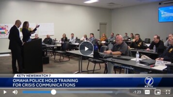 President and CEO Julie Parker and Vice President Christopher Mannino stand in front of public safety officials in a classroom-style crisis communication training in Omaha.